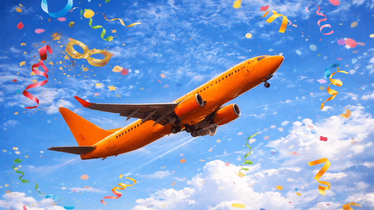 Avião comercial decolando em céu azul com confetes de carnaval coloridos ao redor
